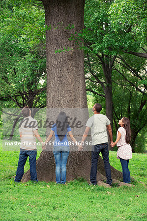 Teenage friends spending time together at tree