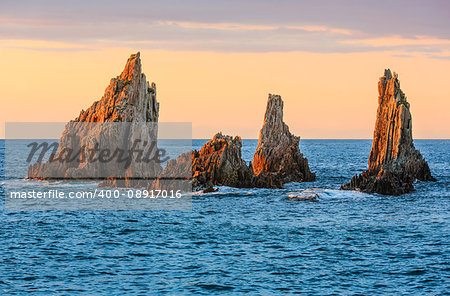 Sharp islets near Gueirua beach (Asturias, Spain). Evening Atlantic ocean landscape.