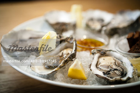 Oysters on a plate with ice and lemon