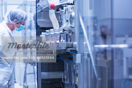Worker operating machinery in pharmaceutical plant