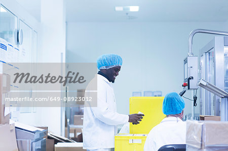 Workers packaging pharmaceutical products in pharmaceutical plant