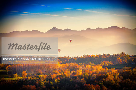 View from hot air balloon of autumn forest and mountains, Langhe, Piedmont, Italy