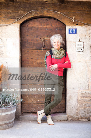 Portrait of woman in doorway looking at camera smiling, Bruniquel, France