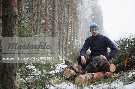 Logger taking break on logs, Tammela, Forssa, Finland