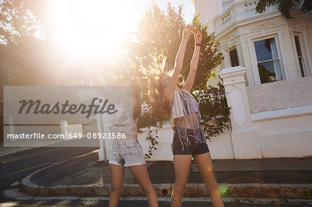 Teenage girls taking selfies in street, Cape Town, South Africa