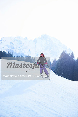 Teenage girl skiing down ski slope, Gstaad, Switzerland