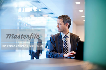 Businessman looking over his shoulder in office