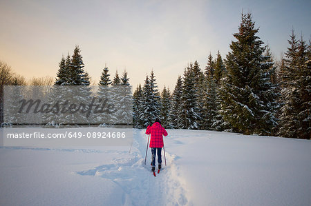 Teenage girl, cross country skiing, rear view, Chusovo, Russia