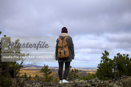 Young woman standing on mountain, looking at view, Sverdlovsk Oblast, Russia