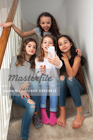 Girls on stairs taking selfie