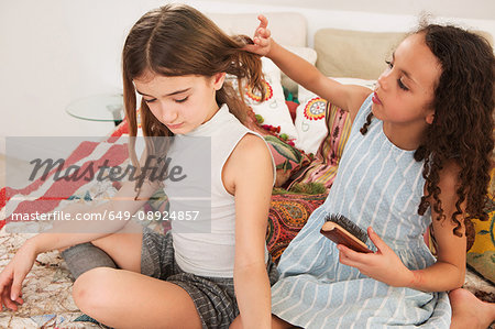 Girls brushing friends hair