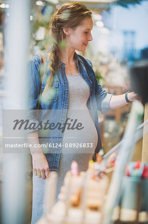Pregnant woman shopping in shop