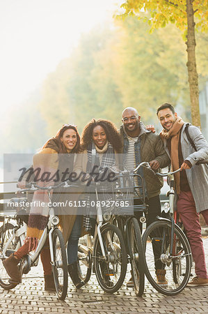 Portrait friends bike riding on urban autumn street