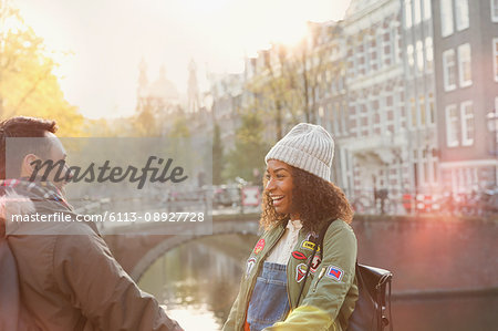 Young couple on urban autumn bridge over canal, Amsterdam