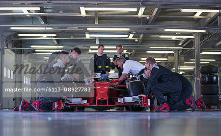 Race car team working on race car in garage