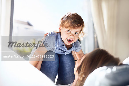 Portrait smiling baby boy on mother's knees