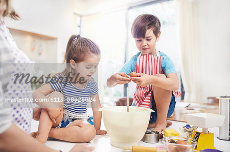 Boy and girl brother and sister baking on kitchen counter