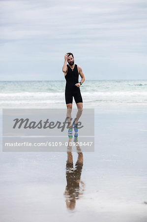 Handsome athlete jogging on the beach