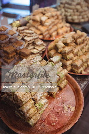 Close-up of turkish sweets in plate on display at counter in shop