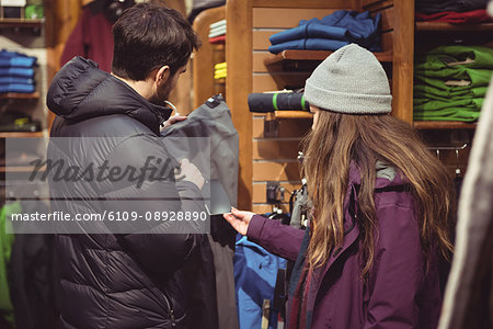 Couple selecting apparel together in a clothes shop