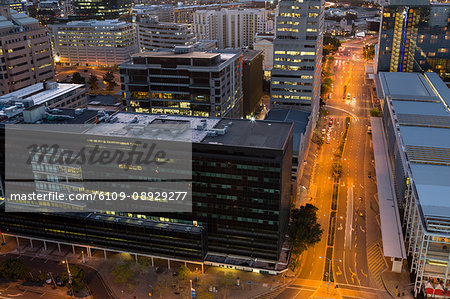 Aerial view of streets and office building in business district at night