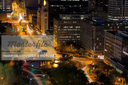 Aerial view of streets and office building in business district at night