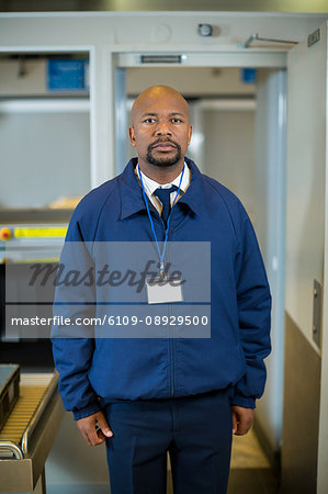 Portrait of airport security officer standing in airport terminal