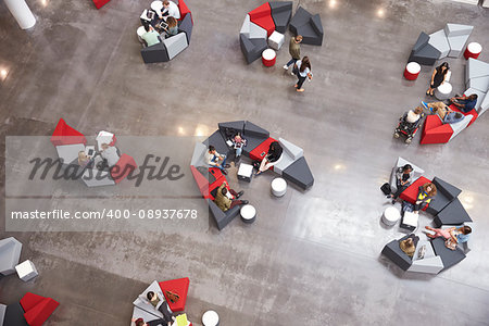 Students groups sitting in a modern university atrium