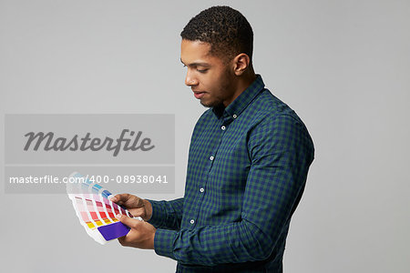 Studio Portrait Of Graphic Designer With Color Swatches