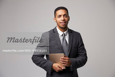 Studio Portrait Of Businessman Using Digital Tablet