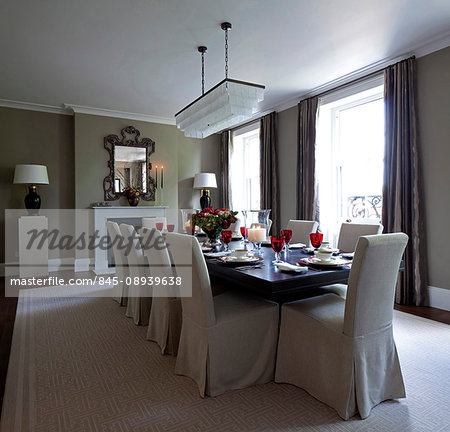 Knightsbridge Apartment, London. A large table laid for dinner. dining table and chairs.