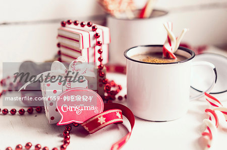 Hot chocolate with candy canes and Christmas decorations