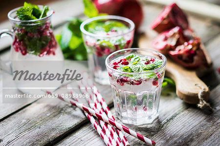 Detox drink with lemon water, mint and pomegranate seeds