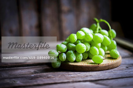 Green grapes on a rustic wooden surface