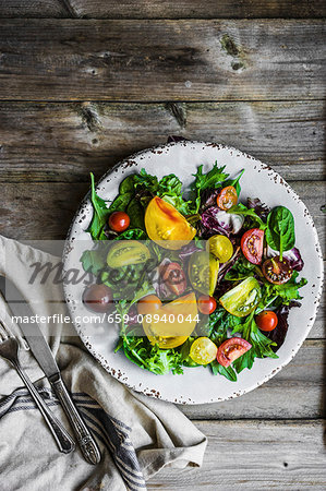 A mixed salad with spinach, rocket and heirloom tomatoes