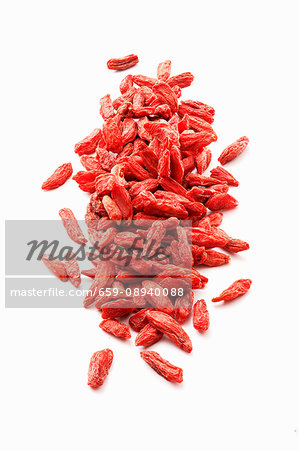 Dried goji berries on a white surface