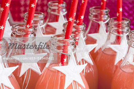 Fruit juice in glass bottles decorated with white stars