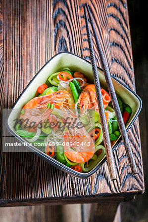 Prawns and vegetables served with rice noodles (Thailand)