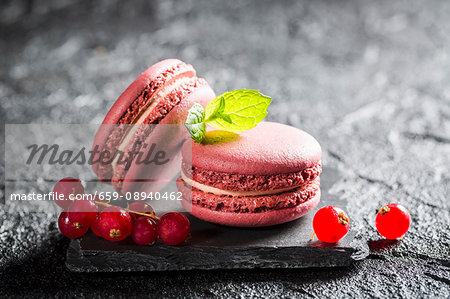 Redcurrant macaroons on a black stone