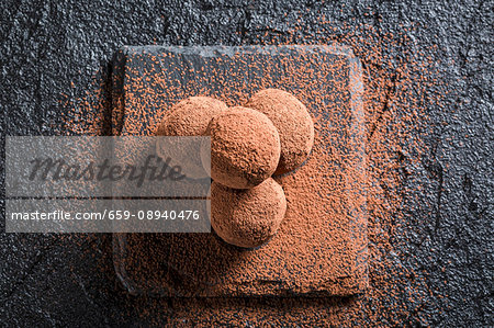 Chocolate pralines on a black stone