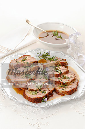 Roast veal wrapped in ham with rosemary