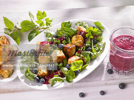 Herb salad with roasted sheep's cheese and fruits of the forest vinaigrette