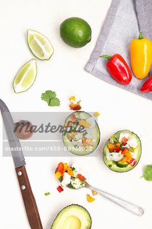 White fish ceviche with cucumber, peppers and coriander served in an avocado White fish ceviche with cucumber, peppers and coriander served in an avocado