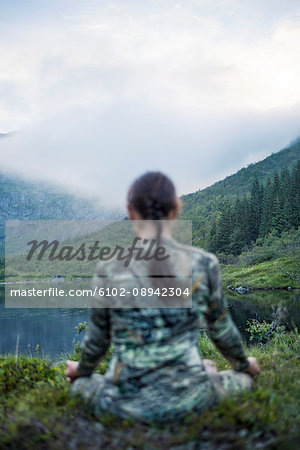 Woman meditating in mountains