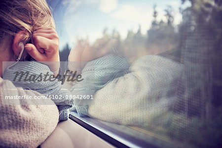 Woman sleeping near window in train