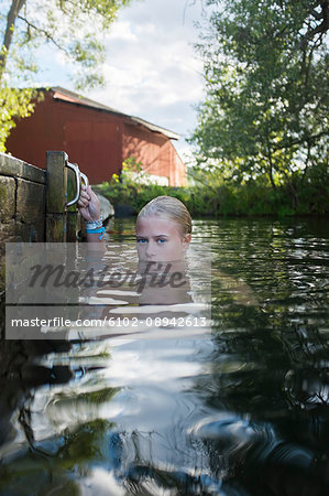 Teenage girl swimming by jetty