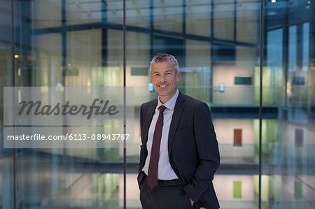Portrait smiling, confident businessman in modern office atrium Portrait smiling, confident businessman in modern office atrium