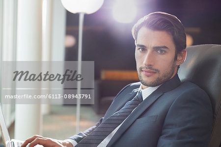 Portrait serious businessman using laptop