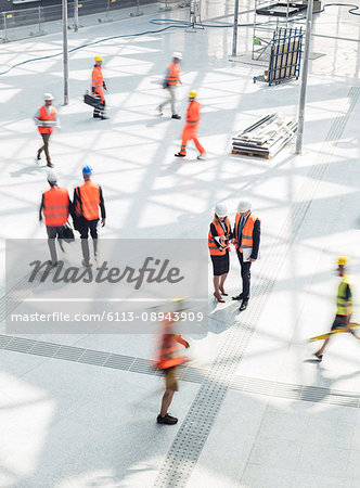 Construction workers and engineers at construction site