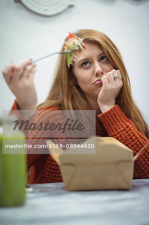 Beautiful woman fed up of eating in the restaurant